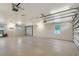 Large two-car garage with modern doors and windows and epoxy floor at 1203 Lyric Ln, Sarasota, FL 34242