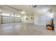 Expansive three-car garage featuring a sealed concrete floor, with a utility sink and two service doors at 1203 Lyric Ln, Sarasota, FL 34242