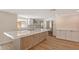 Modern kitchen featuring new stainless steel appliances, a large island, and bright lighting at 1203 Lyric Ln, Sarasota, FL 34242