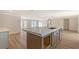 Kitchen featuring stainless steel appliances, a large island with space for seating, and access to the living room at 1203 Lyric Ln, Sarasota, FL 34242