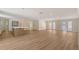 Open living space featuring hardwood floors, recessed lighting, and a view into the kitchen and backyard at 1203 Lyric Ln, Sarasota, FL 34242