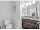 Bathroom with granite vanity and decorative plant hanging next to the toilet at 1234 Harbour Blue St, Ruskin, FL 33570