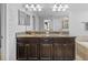 Luxurious bathroom features double vanity sinks, a soaking tub, and glass-enclosed shower at 1234 Harbour Blue St, Ruskin, FL 33570