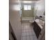 Functional bathroom with a tub and shower combination, tiled walls, and modern sink at 13017 Club Dr, Hudson, FL 34667