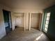 Bedroom with dual closets and access to the bathroom at 13017 Club Dr, Hudson, FL 34667