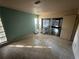 Bedroom with sliding glass doors providing access to the lanai and backyard at 13017 Club Dr, Hudson, FL 34667