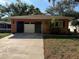 Charming single-story home with a well-maintained lawn, driveway and attached garage in a friendly neighborhood at 13017 Club Dr, Hudson, FL 34667