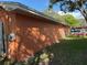 Side view of home showing its peach exterior and a well kept lawn at 13017 Club Dr, Hudson, FL 34667