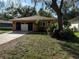 Charming single-story home showcasing a manicured lawn and a two car garage at 13017 Club Dr, Hudson, FL 34667