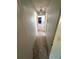 Hallway with neutral tile flooring and a hanging light fixture provides a view to another room at 13017 Club Dr, Hudson, FL 34667