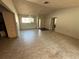 Open living room with large windows, and tiled flooring offers a bright living space at 13017 Club Dr, Hudson, FL 34667