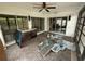 Enclosed sunroom with sliding glass doors and ceiling fan offers lots of natural light and outdoor living at 13017 Club Dr, Hudson, FL 34667