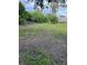 Picture of a large backyard with grass and scattered shrubbery at 14396 Pambar Ave, Port Charlotte, FL 33953