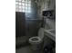 Functional bathroom featuring a shower with glass block window at 14396 Pambar Ave, Port Charlotte, FL 33953