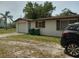 Modest single-story home with a one car garage, and simple landscaping at 14396 Pambar Ave, Port Charlotte, FL 33953