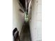Exterior shot of a narrow passageway between a home and a wall at 14396 Pambar Ave, Port Charlotte, FL 33953