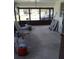 Enclosed porch with concrete flooring and metal chairs at 14396 Pambar Ave, Port Charlotte, FL 33953