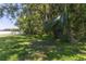 Spacious backyard featuring lush greenery and a well-maintained lawn, perfect for outdoor activities at 15508 High Bell Pl, Bradenton, FL 34212