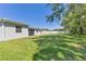 A lush green backyard with a well-maintained lawn and mature trees creates a private oasis at 15508 High Bell Pl, Bradenton, FL 34212