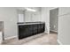 Bathroom boasts a black vanity with granite countertops and neutral tile flooring at 15508 High Bell Pl, Bradenton, FL 34212