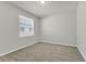 Bedroom features plush carpeting, a ceiling light, and a sunlit window at 15508 High Bell Pl, Bradenton, FL 34212
