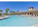 Stunning community pool with inviting lounge chairs and palm trees, perfect for relaxation and recreation at 15508 High Bell Pl, Bradenton, FL 34212