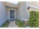 Charming entryway with a gray front door, stone accents, and well-manicured landscaping at 15508 High Bell Pl, Bradenton, FL 34212