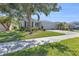 Beautiful home exterior with a three-car garage, lush lawn, and mature landscaping for curb appeal at 15508 High Bell Pl, Bradenton, FL 34212