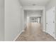 Open-concept foyer flows into the living area showcasing neutral walls and light-colored tile flooring at 15508 High Bell Pl, Bradenton, FL 34212