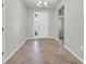 Inviting foyer features neutral walls, a decorative light fixture and light-colored tile flooring at 15508 High Bell Pl, Bradenton, FL 34212