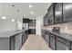 Modern kitchen featuring dark cabinets, stainless steel appliances, and a convenient center island at 15508 High Bell Pl, Bradenton, FL 34212