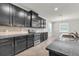 The stylish kitchen is equipped with dark cabinets, stainless steel appliances and sleek countertops at 15508 High Bell Pl, Bradenton, FL 34212