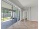 Bright living area with large sliding glass doors to a screened-in patio with tile flooring at 15508 High Bell Pl, Bradenton, FL 34212