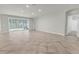 Large living area with big sliding doors bringing in natural light and views of the outdoor space at 15508 High Bell Pl, Bradenton, FL 34212