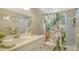 Bathroom with a tropical floral shower curtain, decorative art and vanity at 1838 Restful Dr # K-1, Bradenton, FL 34207