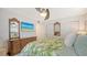 Comfortable bedroom with closet space, TV and vibrant tropical-patterned bedding at 1838 Restful Dr # K-1, Bradenton, FL 34207