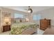 Bright bedroom with tropical print bedding, side tables and natural light at 1838 Restful Dr # K-1, Bradenton, FL 34207