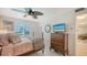 Charming bedroom with a TV, ceiling fan and natural light from the window at 1838 Restful Dr # K-1, Bradenton, FL 34207