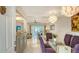 Open concept dining room with glass table, stylish chairs, and view of living area at 1838 Restful Dr # K-1, Bradenton, FL 34207