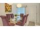 Dining room with glass table, seating for six, modern lighting, and bright natural light at 1838 Restful Dr # K-1, Bradenton, FL 34207
