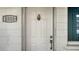 Close-up of front door with decorative pineapple knocker and house number at 1838 Restful Dr # K-1, Bradenton, FL 34207