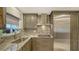 Kitchen with stainless steel appliances, stone countertops, and ample cabinet space at 1838 Restful Dr # K-1, Bradenton, FL 34207