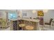 Kitchen island with seating, wine rack, marble countertops and open concept to dining and living areas at 1838 Restful Dr # K-1, Bradenton, FL 34207