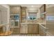 Updated kitchen with stainless steel appliances, modern cabinets and countertop, open view of the dining room at 1838 Restful Dr # K-1, Bradenton, FL 34207