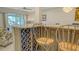 Close up of kitchen island with seating and wine rack, open concept to dining and living areas at 1838 Restful Dr # K-1, Bradenton, FL 34207