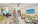 Bright living room featuring tile flooring, ceiling fan, comfortable seating, and an adjacent dining area and kitchen at 1838 Restful Dr # K-1, Bradenton, FL 34207