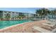 Community outdoor pool and deck with lounge chairs at 1838 Restful Dr # K-1, Bradenton, FL 34207