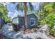 Backyard exterior with stone pathway, tropical foliage and a freshly painted exterior at 1919 Laurel St, Sarasota, FL 34236