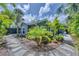 Charming home with lush tropical landscaping, stone pathway, and a freshly painted exterior at 1919 Laurel St, Sarasota, FL 34236
