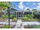 Home featuring a landscaped front yard, walkway to a screened front porch and an American flag at 1919 Laurel St, Sarasota, FL 34236